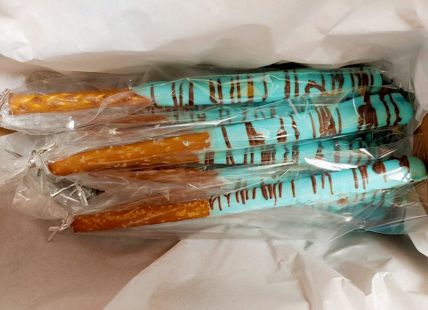 Chocolate-dipped pretzel rods, blue chocolate pretzels, elegant pretzel favors, party treats, chocolate-dipped snacks, baby shower edible favors, gourmet pretzel rods, handmade dessert gifts.